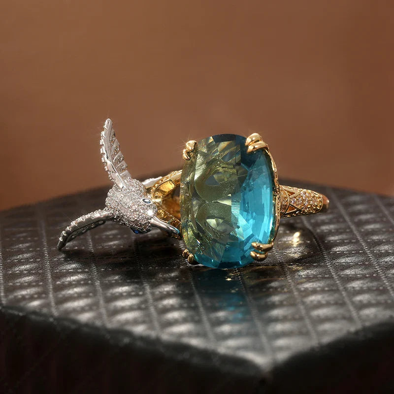 Anello Regolabile Colore Acquamarina con Colibrì – Placcato Oro 14K